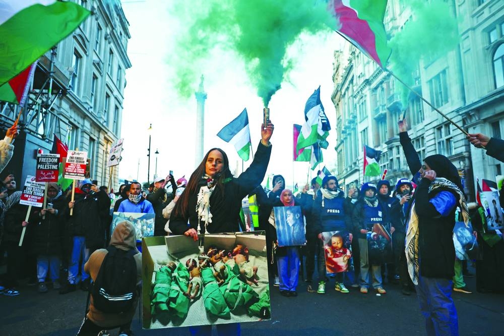 
Protesters hold images of children, as they take part in a ‘National March For Palestine’ in central London yesterday calling for a ceasefire in the conflict between Israel and Hamas. 