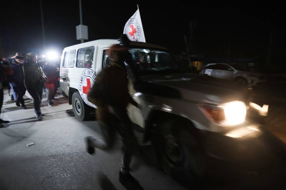 A Red Cross vehicle, as part of a convoy believed to be carrying hostage arrives at the Rafah border, amid a hostages-prisoners swap deal between Hamas and Israel, in southern Gaza Strip Saturday late night. REUTERS