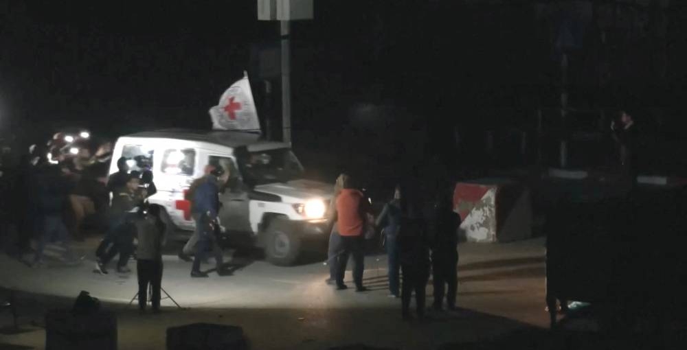 A Red Cross vehicle, as part of a convoy believed to be carrying hostage arrives at the Rafah border, amid a hostages-prisoners swap deal between Hamas and Israel, in southern Gaza Strip Saturday late night. REUTERS