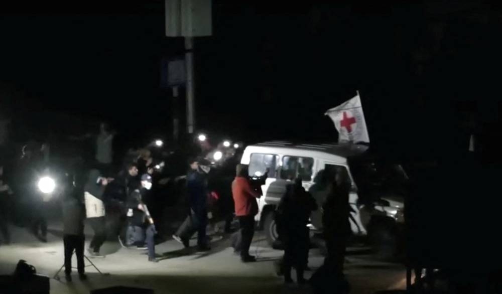 A Red Cross vehicle, as part of a convoy believed to be carrying hostages arrives at the Rafah border, amid a hostages-prisoners swap deal between Hamas and Israel, in southern Gaza Strip Saturday night. REUTERS