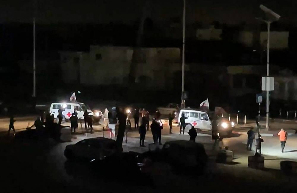 A Red Cross vehicle, as part of a convoy believed to be carrying hostages arrives at the Rafah border, amid a hostages-prisoners swap deal between Hamas and Israel, in southern Gaza Strip Saturday night. REUTERS