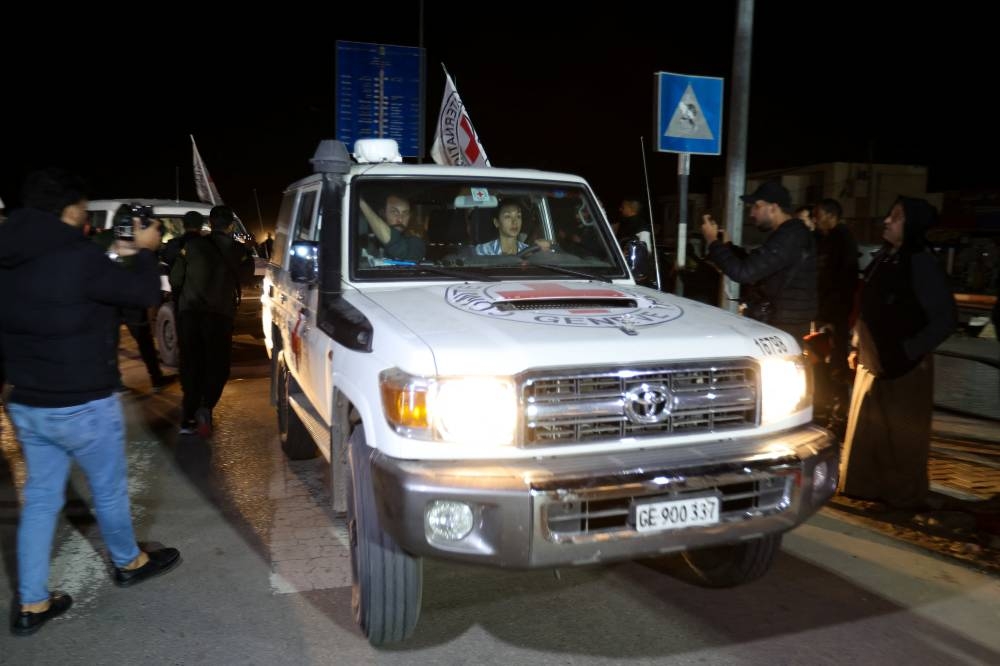A Red Cross vehicle, as part of a convoy carrying hostages arrives at the Rafah border Sunday. REUTERS