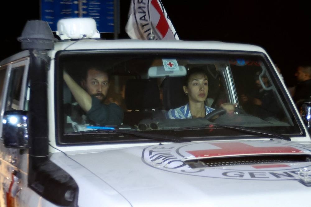 A Red Cross vehicle, as part of a convoy carrying hostages arrives at the Rafah border Sunday. REUTERS