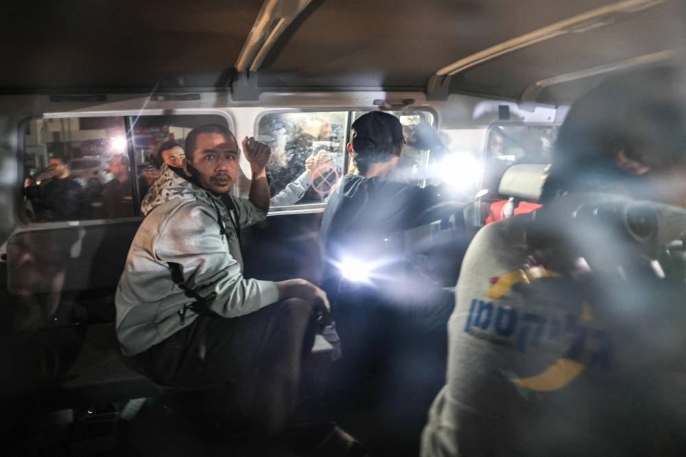 An International Red Cross vehicles reportedly carrying hostages released by Hamas in the Gaza Strip driving towards the Rafah border point with Egypt ahead of their transfer to Israel. AFP