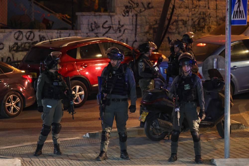Israeli security forces stand guard in east Jerusalem as they secure the area for the arrival of Palestinian prisoners released from the Israeli jails in exchange for hostages freed by Hamas in Gaza, on Sunday. AFP