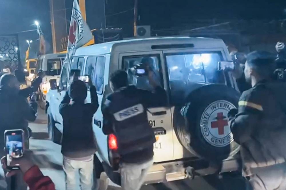  International Red Cross vehicles carrying hostages released by Hamas in the Gaza Strip driving towards the Rafah border point with Egypt ahead of their transfer to Israel.  AFP