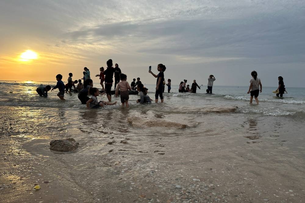 Palestinians spend time on a beach during a temporary truce between Hamas and Israel, in Deir al-Balah in the central Gaza Strip Saturday. REUTERS