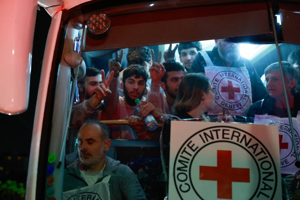 Released Palestinian prisoners react in a vehicle as they leave the Israeli military prison, Ofer, amid a hostages-prisoners swap deal between Hamas and Israel, in Ramallah in the Israeli-occupied West Bank on Sunday. REUTERS