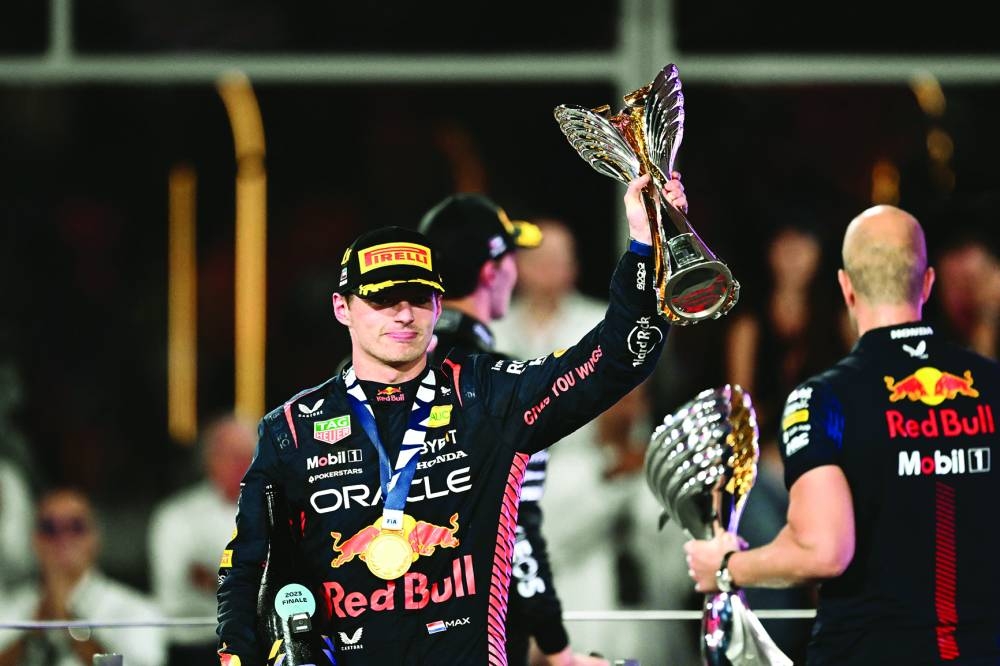 Red Bull Racing's Dutch driver Max Verstappen celebrates with the trophy on the podium after winning the Abu Dhabi Formula One Grand Prix at the Yas Marina Circuit in the Emirati city yesterday. (AFP)