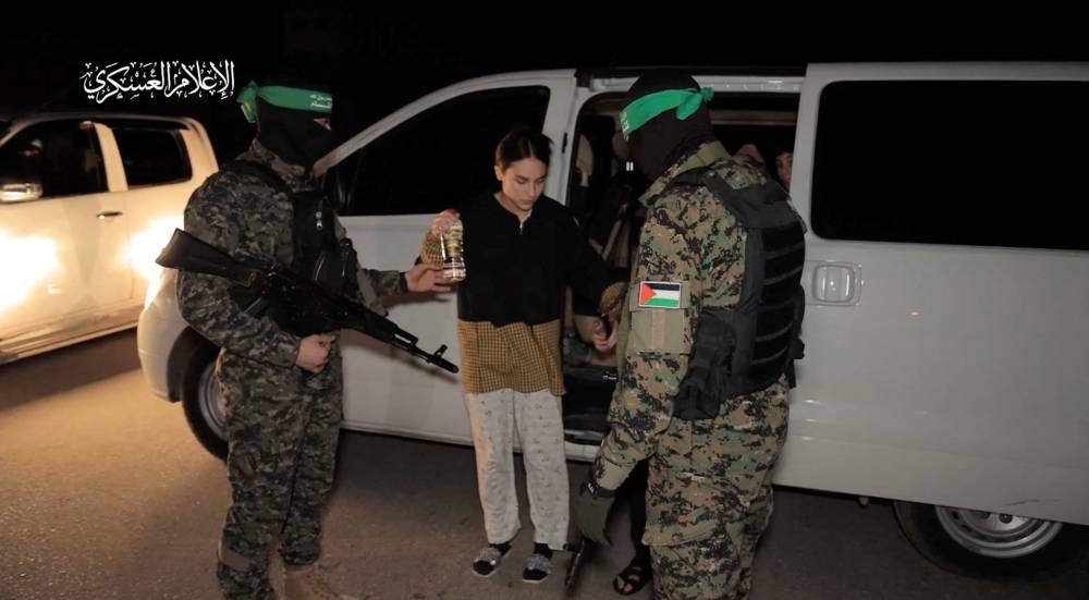 Hostages are handed over by Hamas to members of the International Committee of the Red Cross in an unknown location in the Gaza Strip, in this screen-grab taken from video released Monday. Hamas Military Wing/Handout via REUTERS