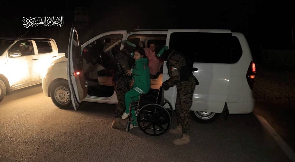Hostages are handed over by Hamas to members of the International Committee of the Red Cross in an unknown location in the Gaza Strip, in this screen-grab taken from video released Monday. Hamas Military Wing/Handout via REUTERS