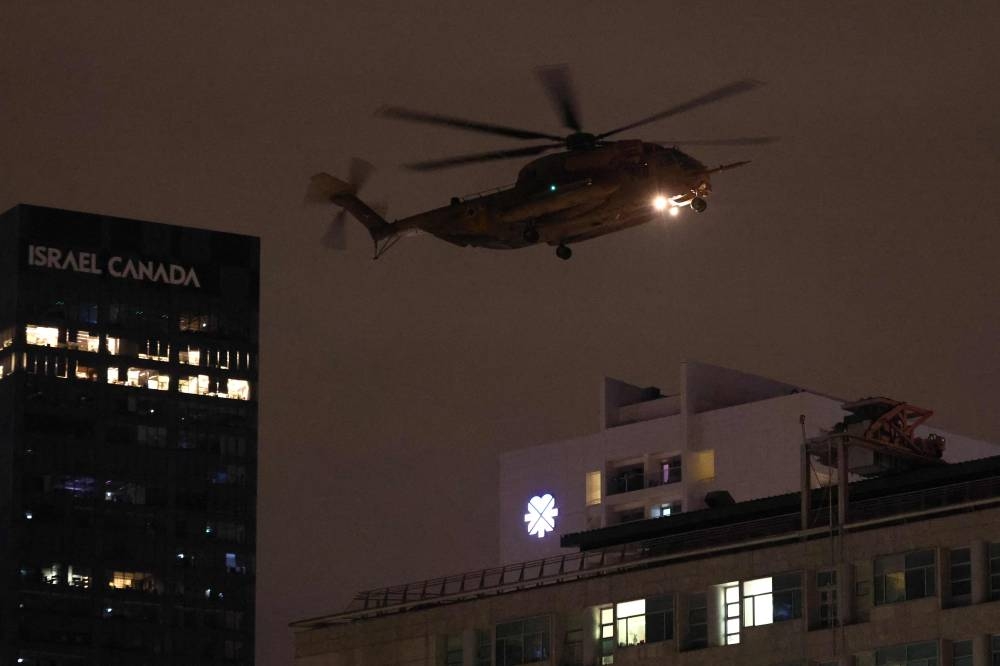 An Israeli helicopter transporting hostages, released by Hamas, prepares to land at the Tel Aviv Sourasky Medical Center in Tel Aviv on Tuesday. Photo by Jack Guez / AFP