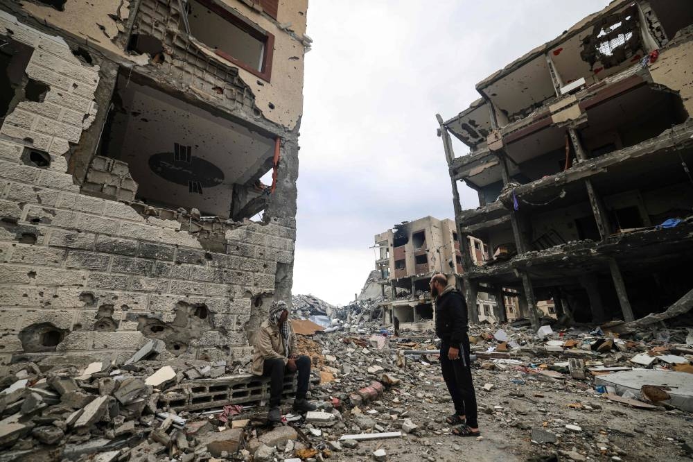 Palestinians inspect the destruction caused by Israeli strikes in Wadi Gaza, in the central Gaza Strip, on Tuesday. AFP