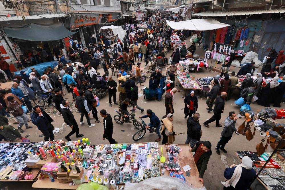 Crowds of people shop in an open-air market in the southern Gaza Strip city of Khan Yunis on Tuesday. AFP