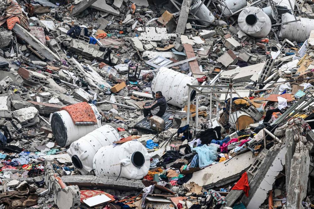 Palestinians inspect the destruction caused by Israeli strikes in Wadi Gaza, in the central Gaza Strip, on Tuesday. AFP