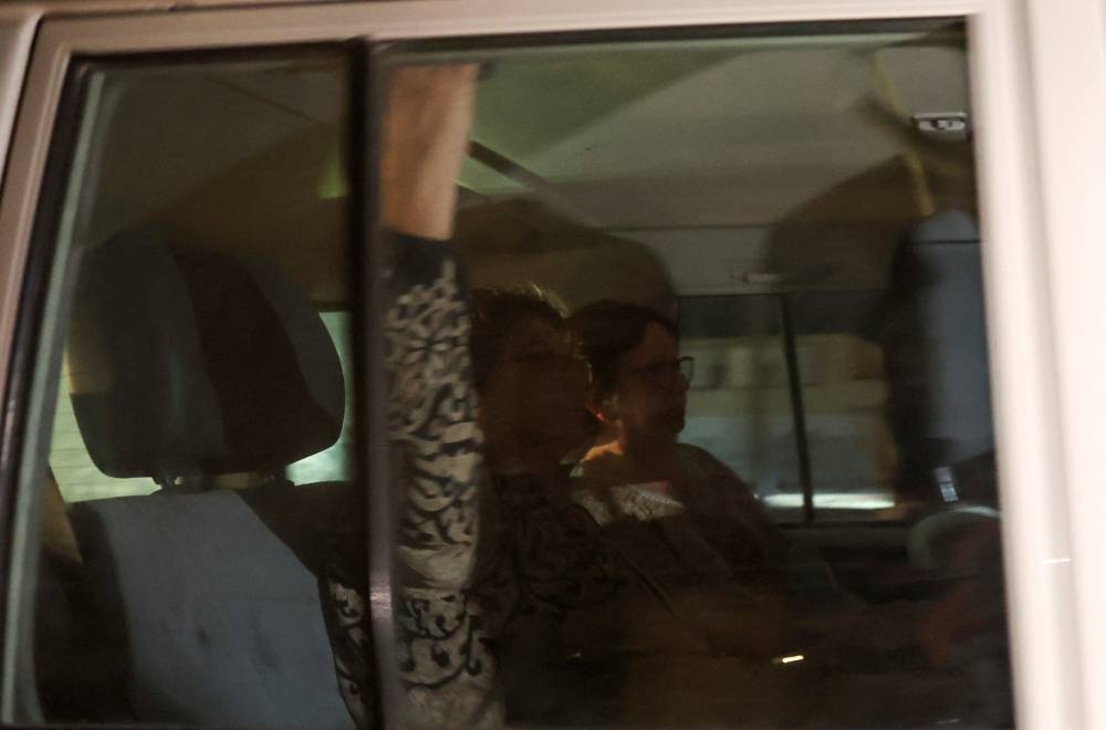 A Red Cross vehicle carrying hostages arrives at Rafah border in southern Gaza Strip, Tuesday. REUTERS