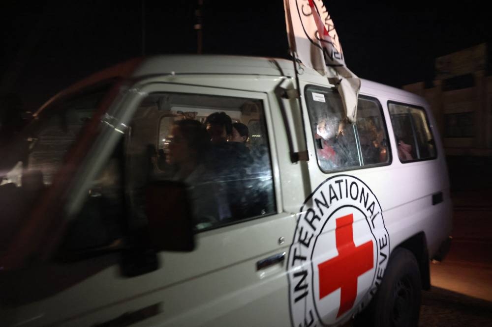 A Red Cross vehicle carrying newly released hostages drives towards the Rafah border point with Egypt, in the southern Gaza Strip on Tuesday. AFP