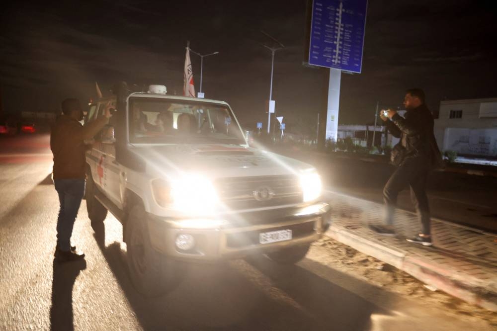 A Red Cross vehicle carrying hostages arrives at Rafah border in southern Gaza Strip, on Tuesday. REUTERS