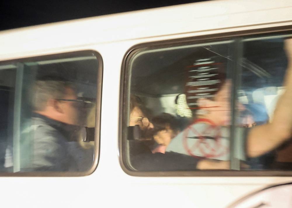 A Red Cross vehicle carrying hostages arrives at Rafah border in southern Gaza Strip, on Tuesday. REUTERS