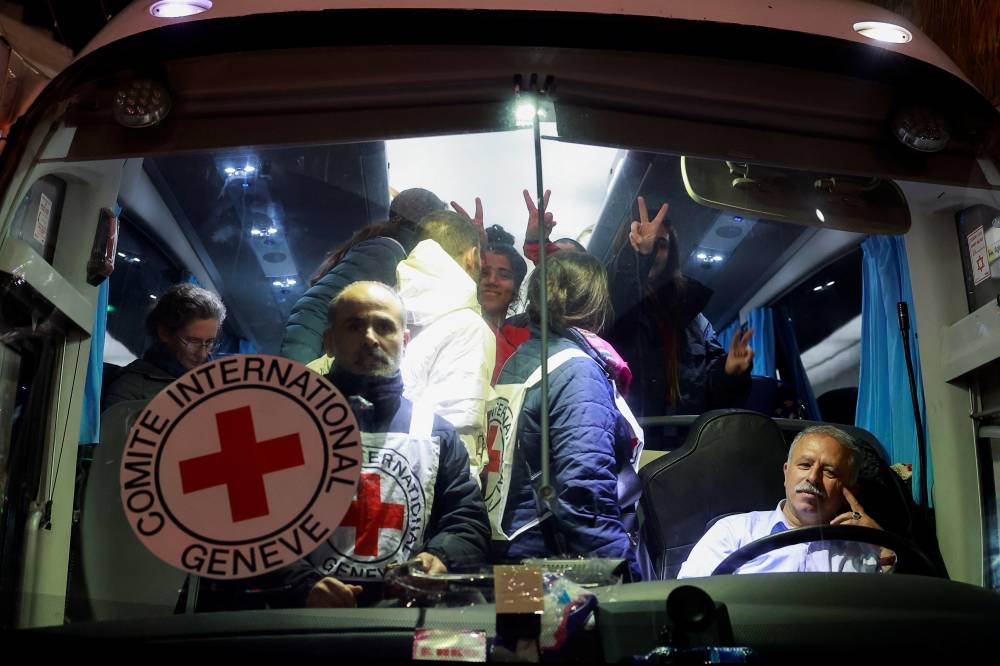 Released Palestinian prisoners react after being released amid a hostages-prisoners swap deal between Hamas and Israel, in Ramallah in the Israeli-occupied West Bank, Tuesday night. REUTERS