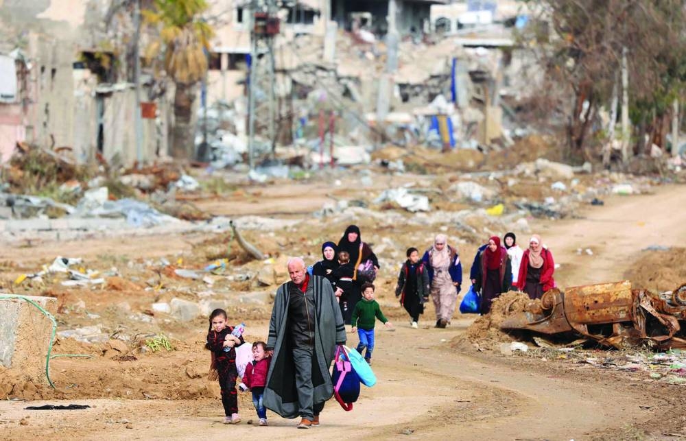 Palestinians fleeing the north walk along the Salaheddine road in the Zeitoun district on the southern outskirts of Gaza City, yesterday.