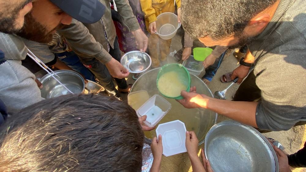 Displaced Palestinians, who fled their houses due to Israeli strikes, gather to receive their portion of lentil soup, at Nasser hospital in Khan Younis in the southern Gaza Strip, on Friday. REUTERS