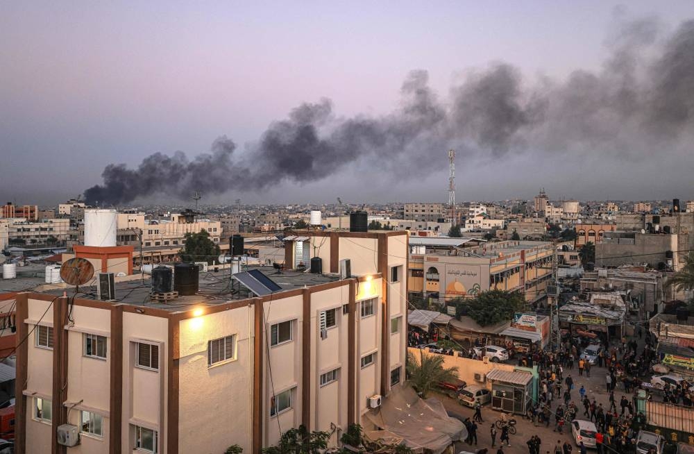 This picture taken in Khan Yunis in the southern Gaza Strip shows black smoke rising after an Israeli strike on a plastic factory, on Saturday. AFP