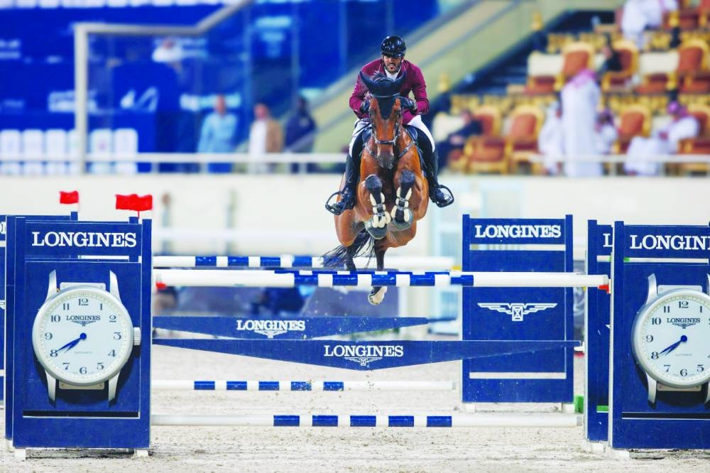 
Mohamed Saeed Haidan clears a rail with his bay gelding Dejavu during the Qatar Equestrian Tour – Longines Hathab yesterday. 