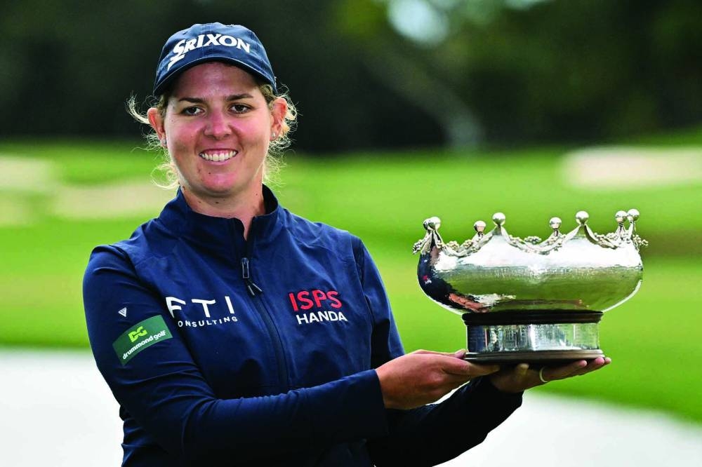 South Africa's Ashleigh Buhai poses with the women's trophy after the Australian Open at The Australian Golf Club in Sydney yesterday. (AFP) 
