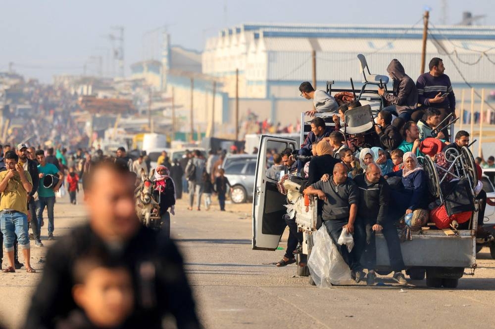 Palestinians flee from Khan Yunis to Rafah in the southern Gaza Strip on Monday, after the Israeli army called on people to leave certain areas in the city. AFP