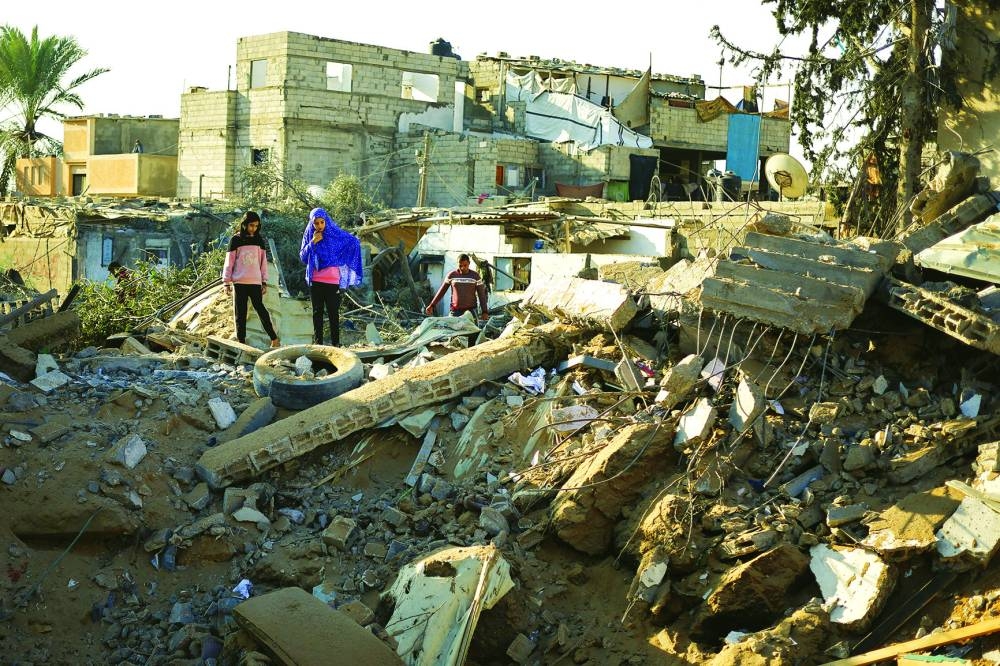 
Palestinians gather at the site of an Israeli strike, amid the ongoing conflict, in Rafah, in the southern Gaza Strip, yesterday. 