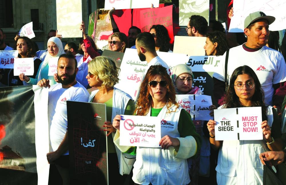 
Members of MSF, Medecins Sans Frontieres (Doctors Without 
Borders), carry placards during a protest demanding an immediate and permanent ceasefire in Gaza, at Martyrs’ Square, downtown Beirut, Lebanon, yesterday. 
