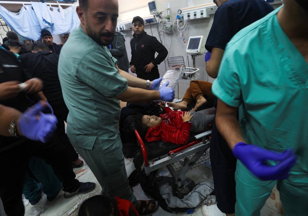 Wounded Palestinians are assisted at Nasser hospital, following Israeli strikes on Ma'an school east of Khan Younis, on Tuesday. REUTERS