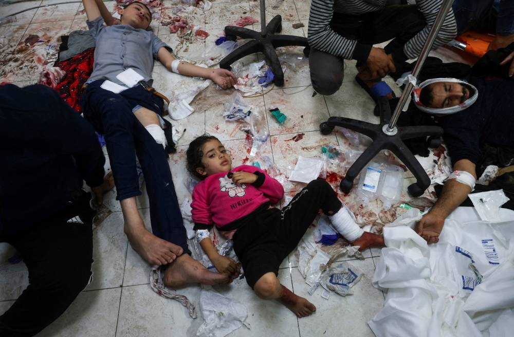 Wounded Palestinians lie on the floor at Nasser hospital, following Israeli strikes on Ma'an school east of Khan Younis, in Khan Younis in the southern Gaza Strip, on Tuesday. REUTERS