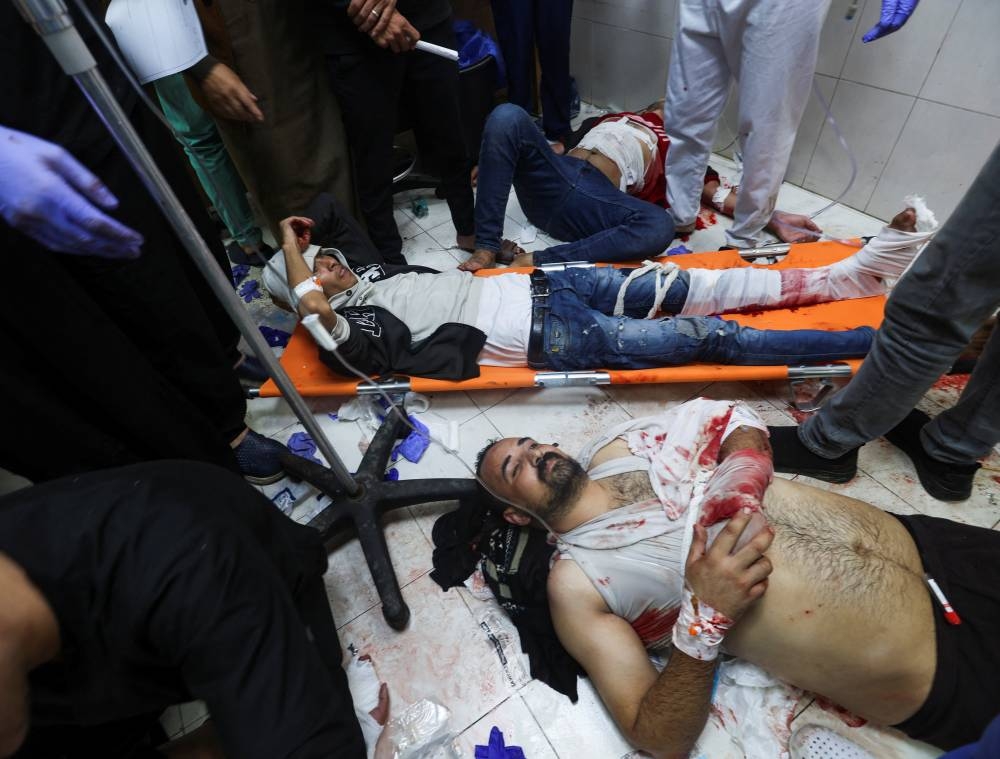 Wounded Palestinians are assisted at Nasser hospital, following Israeli strikes on Ma'an school east of Khan Younis, on Tuesday. REUTERS