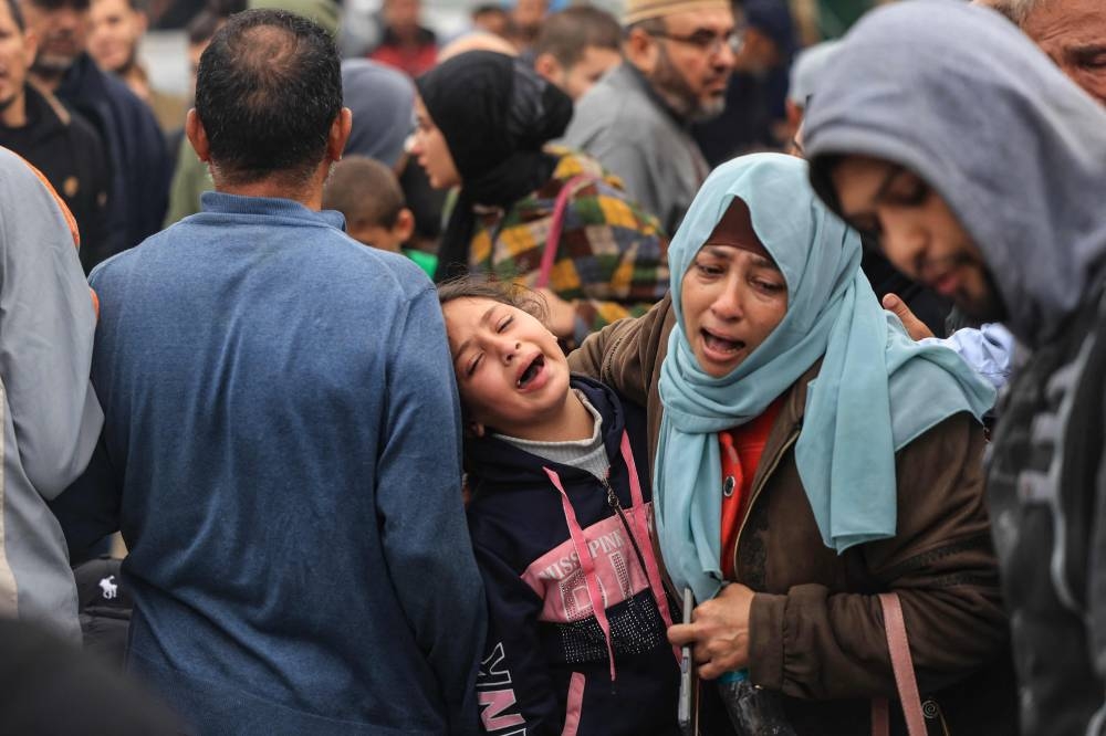 Palestinians mourn the death of loved ones following Israeli bombardment  in the southern Gaza Strip on Tuesday, outside a hospital in Khan Yunis. AFP