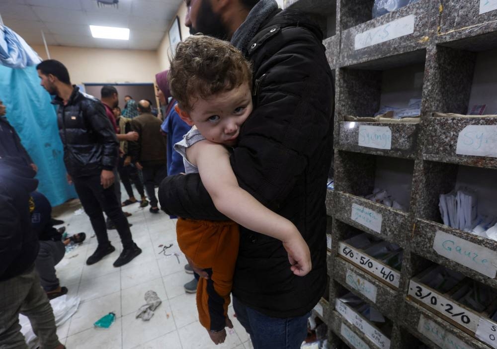 A Palestinian child looks on at Nasser hospital, following Israeli strikes on Ma'an school east of Khan Younis, on Tuesday. REUTERS