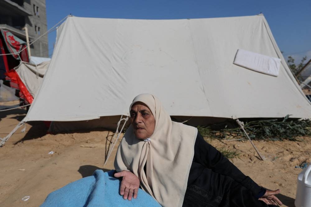 A woman rests outside a tent as displaced Palestinians, who fled their houses due to Israeli strike, shelter in a camp in Rafah in Rafah in the southern Gaza Strip, on Wednesday. REUTERS