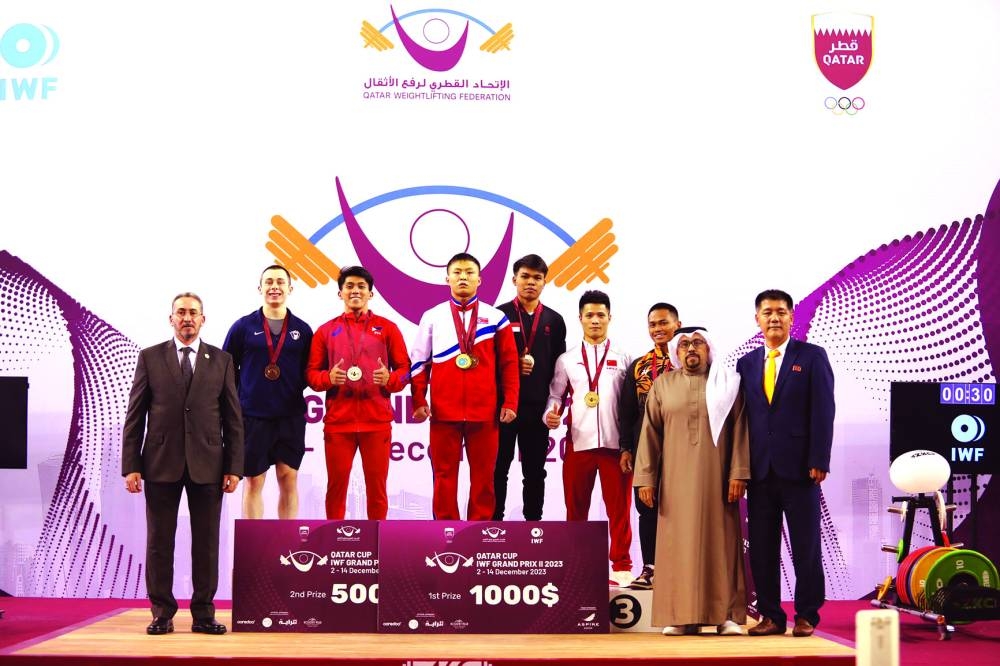 
Podium finishers pose after the men’s 61kg competition on day four of the Qatar Cup IWF Grand Prix II at Aspire Zone in Doha yesterday. 