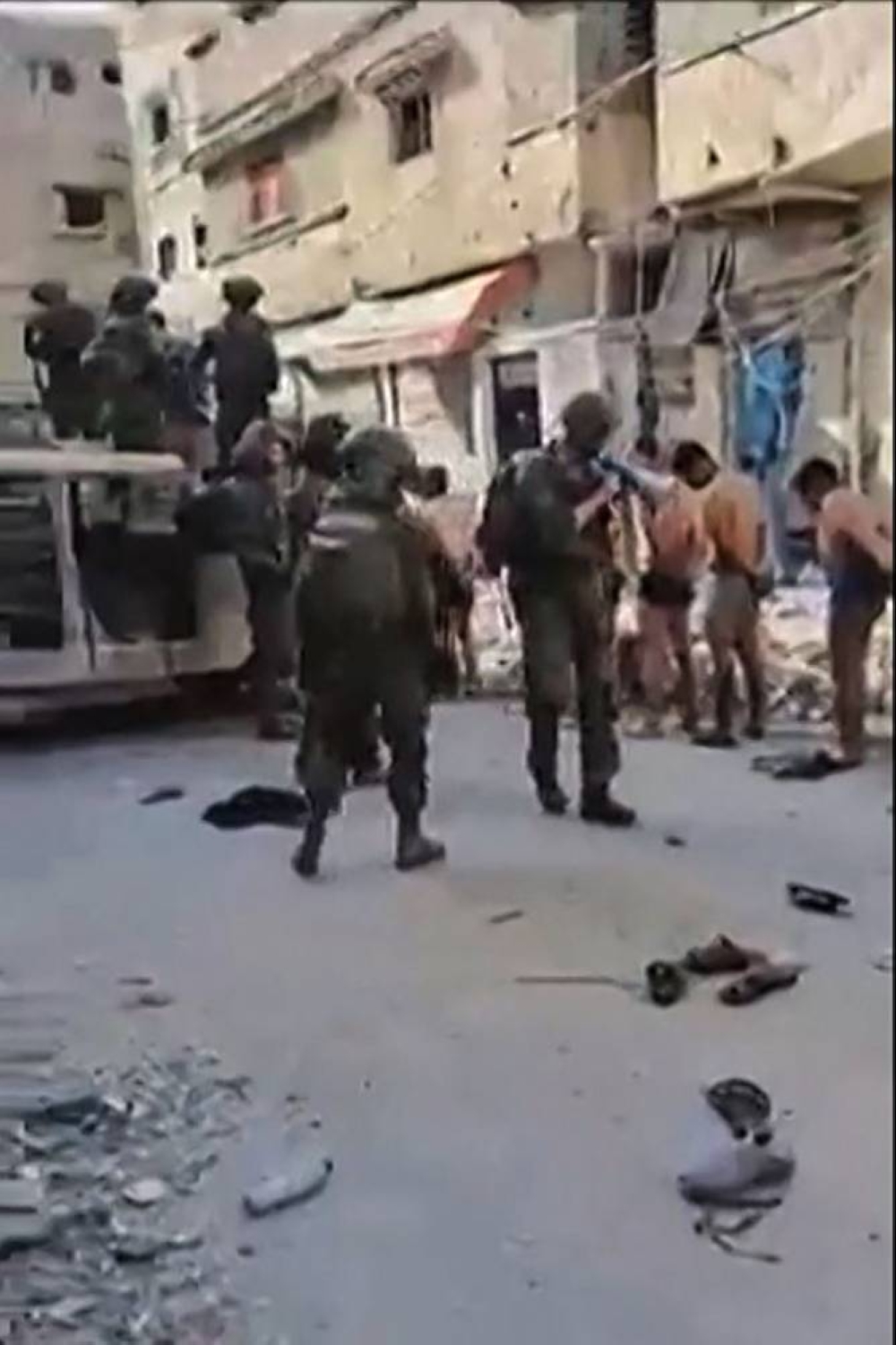 Israeli forces standing guard next to stripped-off, detained Palestinians in Beit Lahia, in the northern Gaza Strip, on Friday. AFP