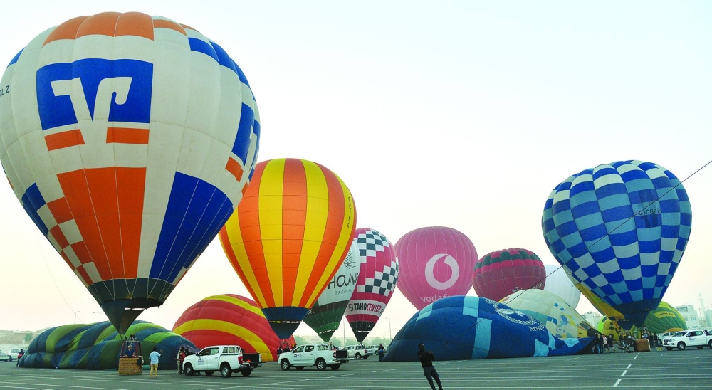 An array of hot air balloons take off near the Khalifa International Stadium, within Aspire Zone, on Friday as part of Qatar Hot Air Balloon Festival's daily 'Sunrise' activity. PICTURE: Shaji Kayamkulam