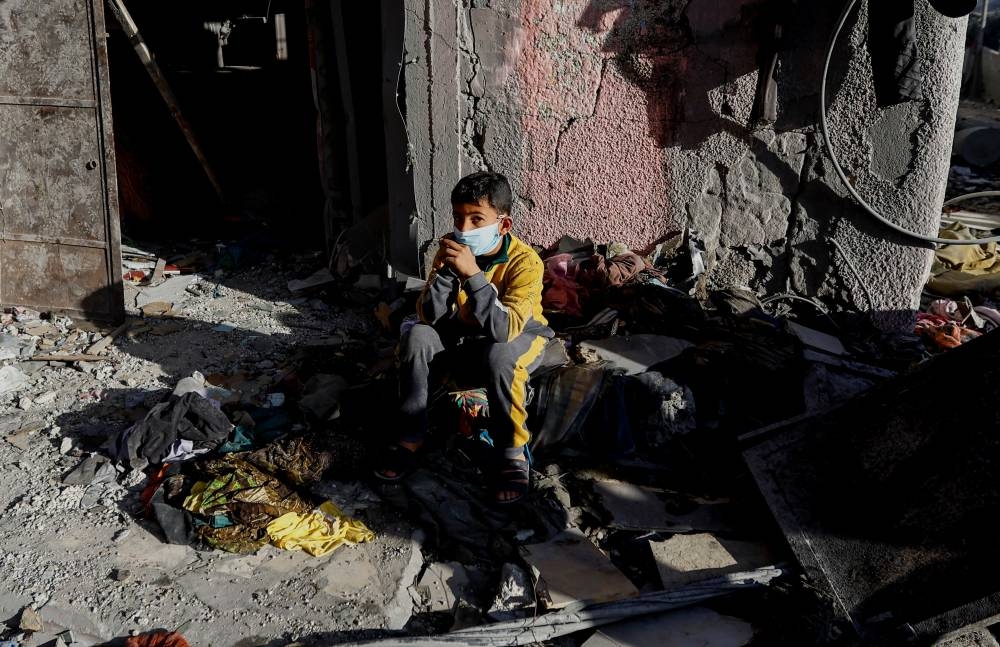 A Palestinian boy reacts after an Israeli strike on a house, in Khan Younis in the southern Gaza Strip, on Saturday. REUTERS