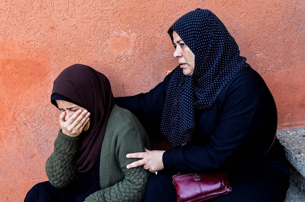 Women mourn during a funeral for Palestinians killed in Israeli strikes during a funeral at Nasser hospital in Khan Younis in the southern Gaza Strip, on Saturday. REUTERS