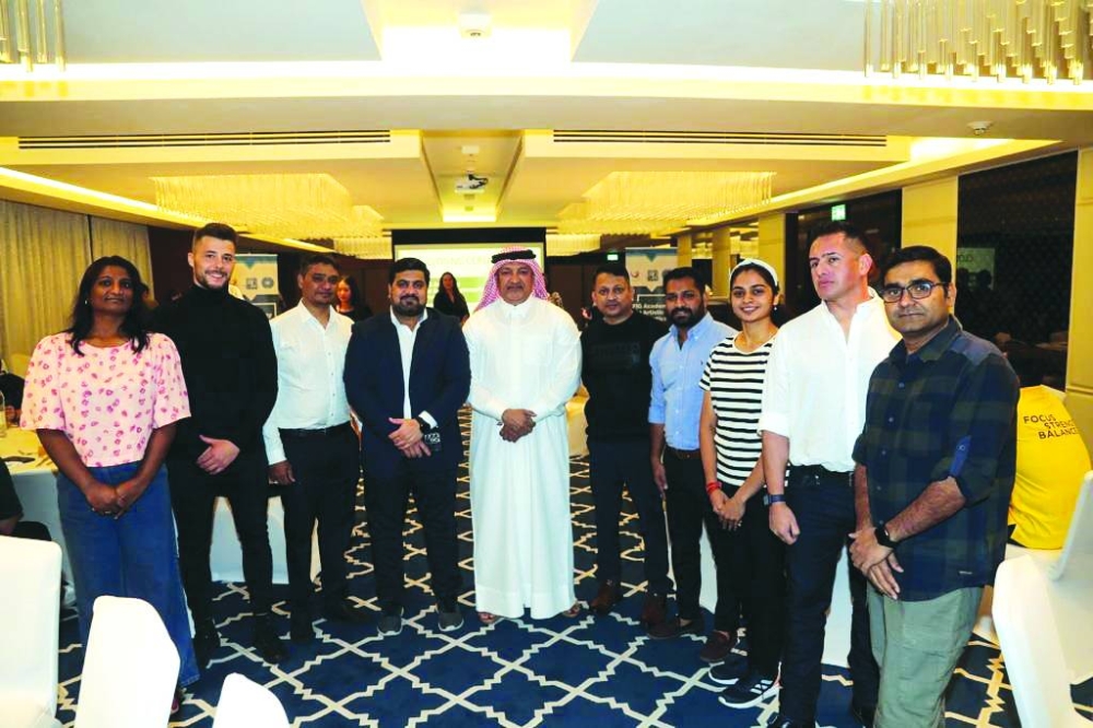 Qatar Gymnastics Federation president Ali al-Hitmi poses participants.