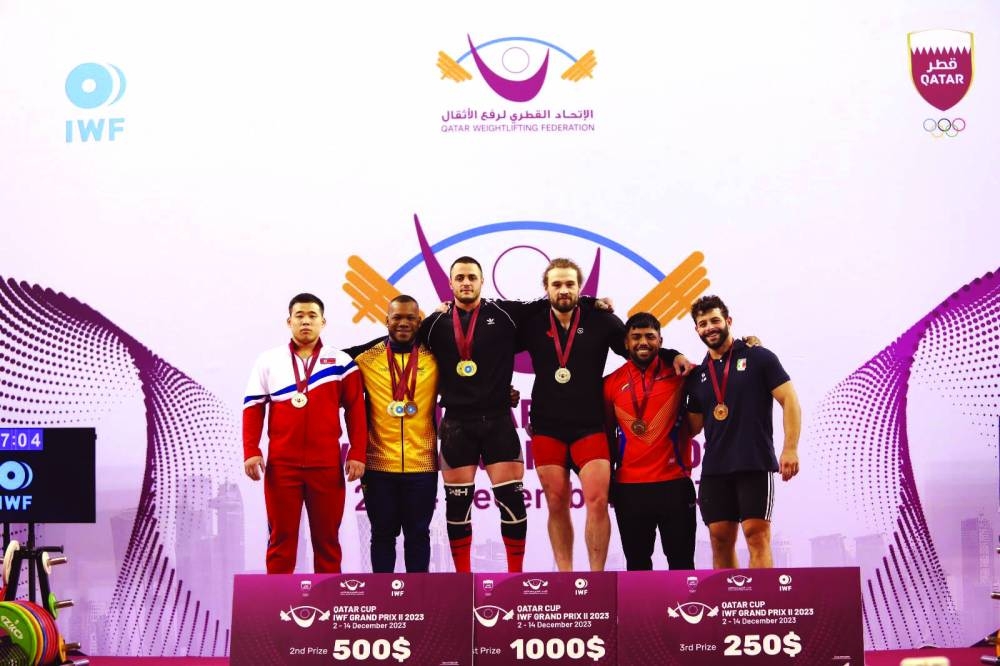 Podium finishers in the men's 89kg competition seen with officials.