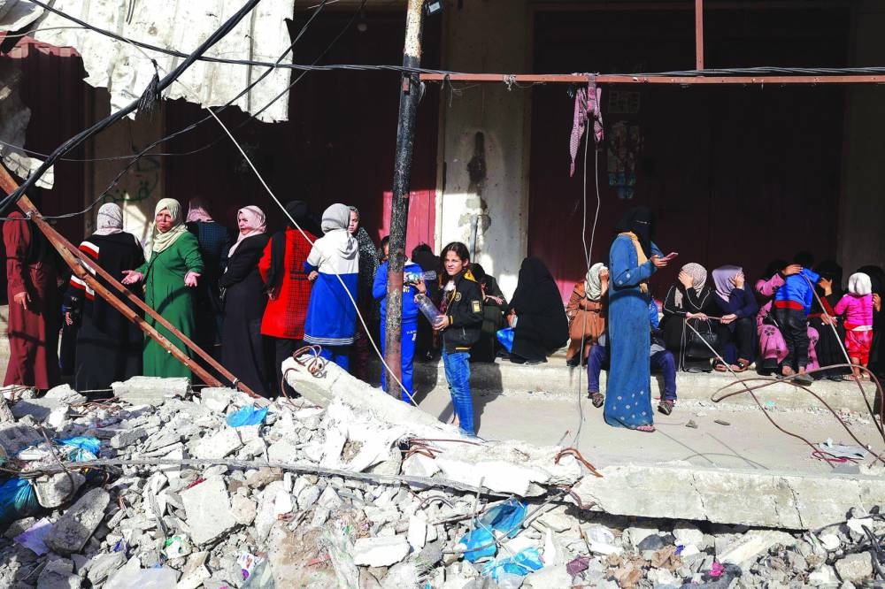 
Displaced Palestinians wait in line to buy sugar in Rafah in the southern Gaza Strip, yesterday. 