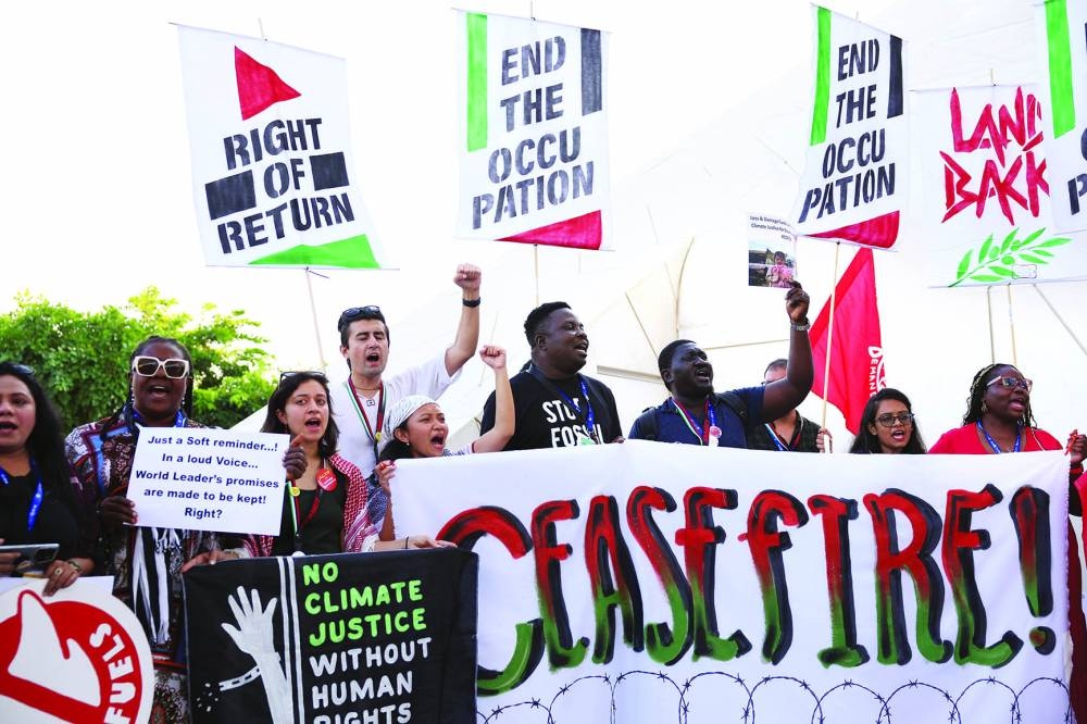 
People take part in a protest in solidarity with Palestinians in Gaza, amid the ongoing conflict, during the UN Climate Change Conference COP28 in Dubai, yesterday. 