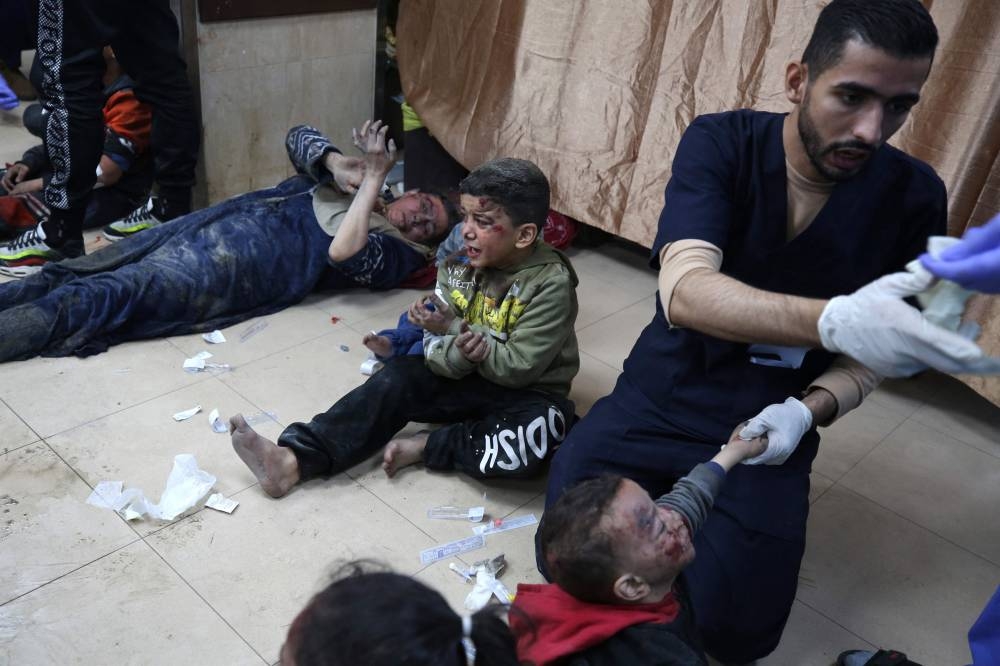 Palestinians injured following Israeli strikes on al-Maghazi refugee camp receive care at Al-Aqsa hospital in Deir Balah in the central Gaza Strip, on Monday. AFP