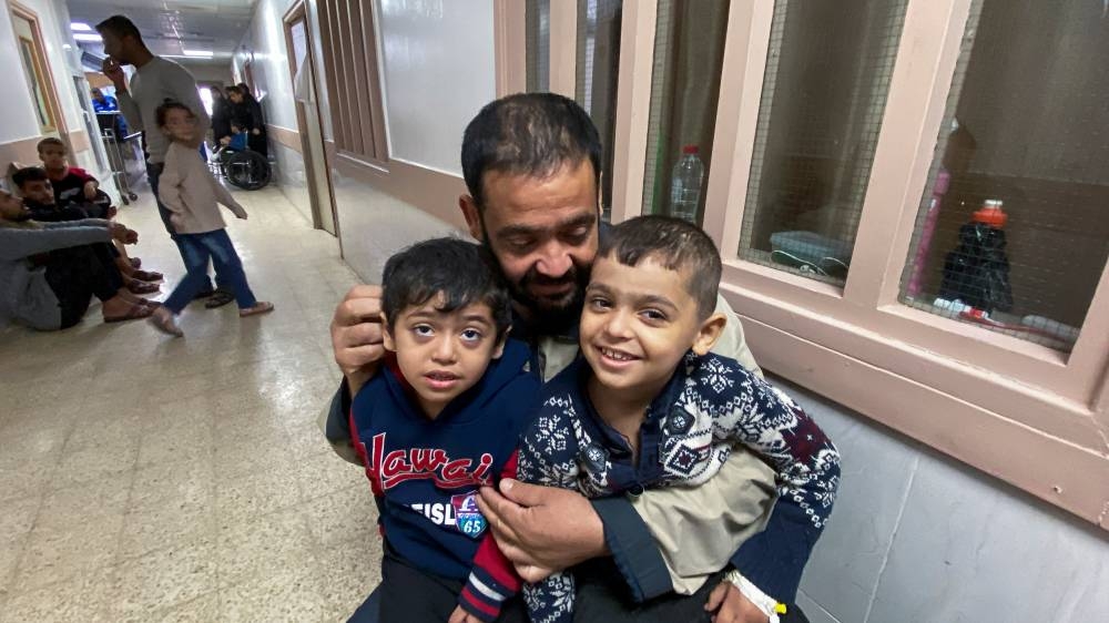 Mosab al-Kahlout, a Palestinian man whose wife and daughter were killed when their home in the Jabalia refugee camp was bombarded in Israeli strikes and has been left alone to care for his two injured sons Bara and Saad, sits with his sons at the European Hospital in Khan Younis in the southern Gaza Strip Sunday. REUTERS