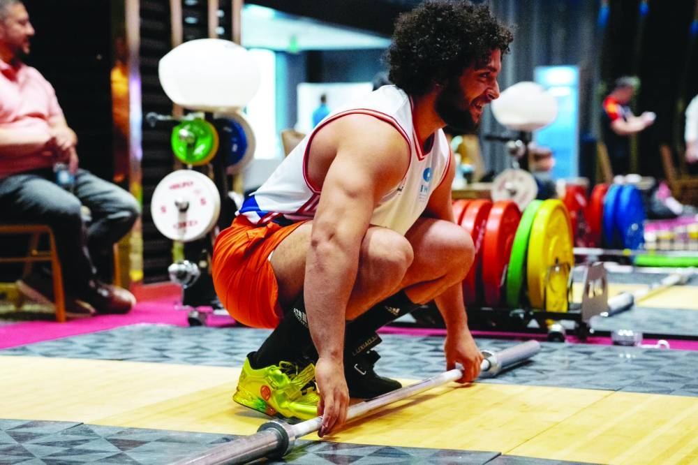 Qatar’s Fares Ibrahim trains ahead of his competition at the Qatar Cup IWF Grand Prix II.